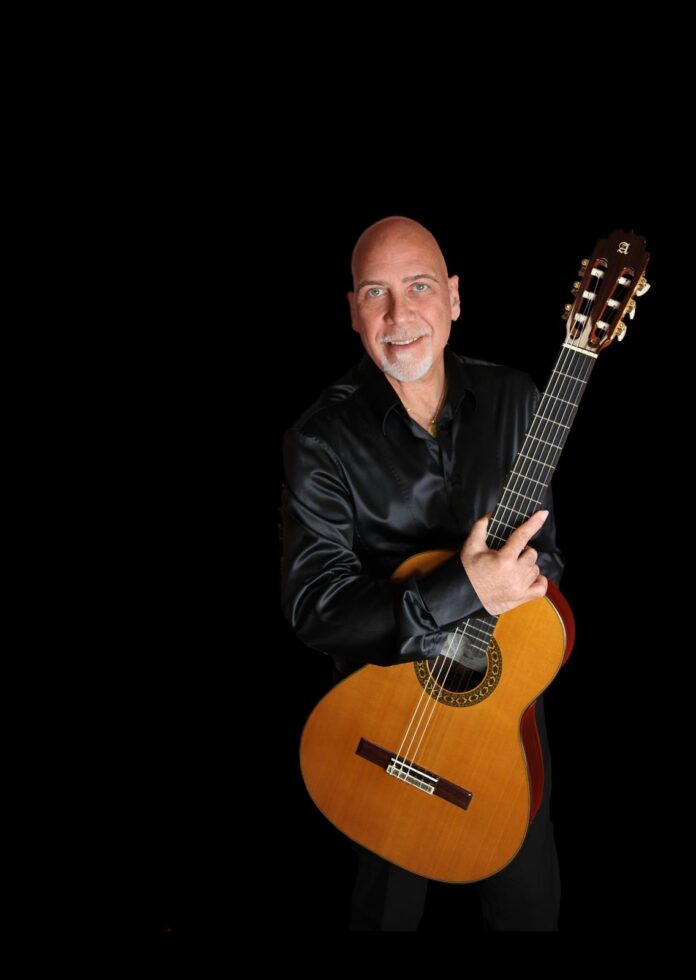 Roberto Fabbri insieme a un quartetto d'archi femminile, con chitarra classica, in abbigliamento elegante su sfondo nero.