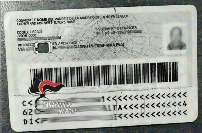 Documento di identità elettronico (CIE) con foro chirurgico al centro, visibile il logo dei carabinieri